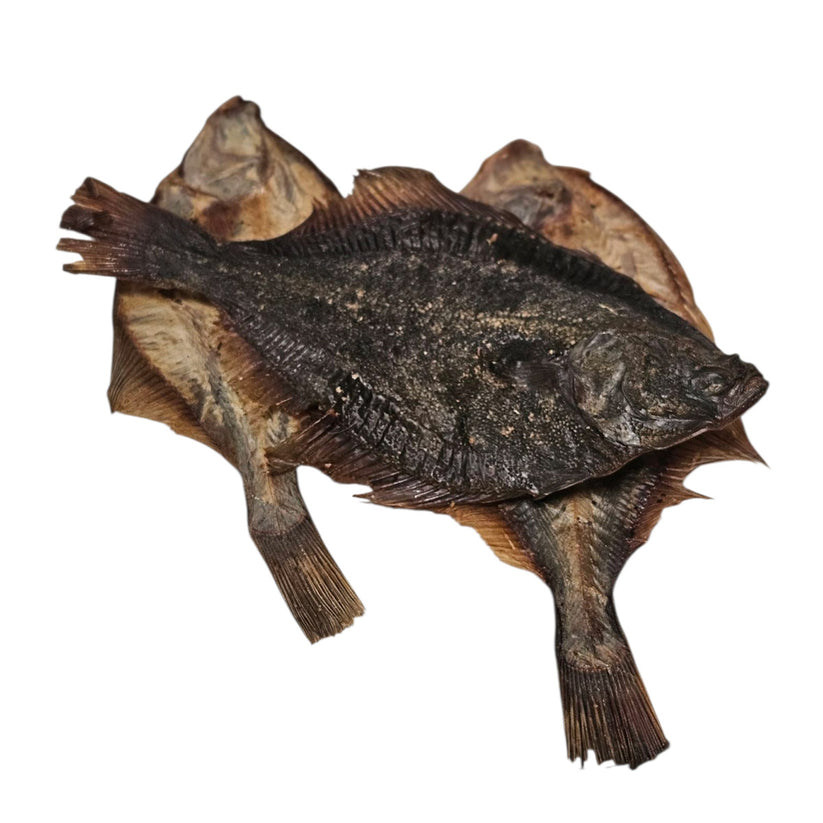 Air-dried whole flounder fish dog treat, naturally preserved and rich in protein and omega oils, displayed on a white background.