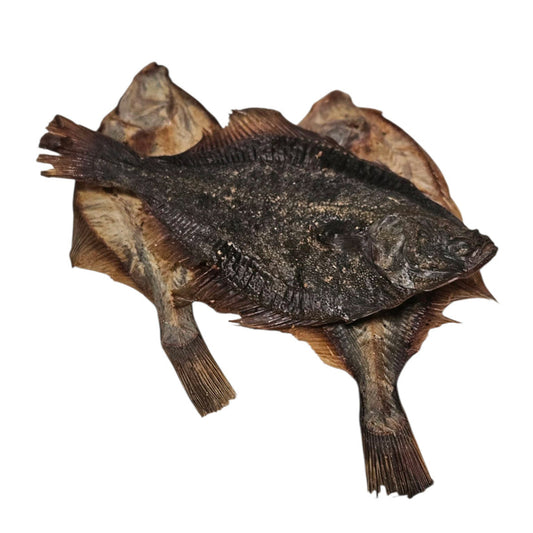 Air-dried whole flounder fish dog treat, naturally preserved and rich in protein and omega oils, displayed on a white background.