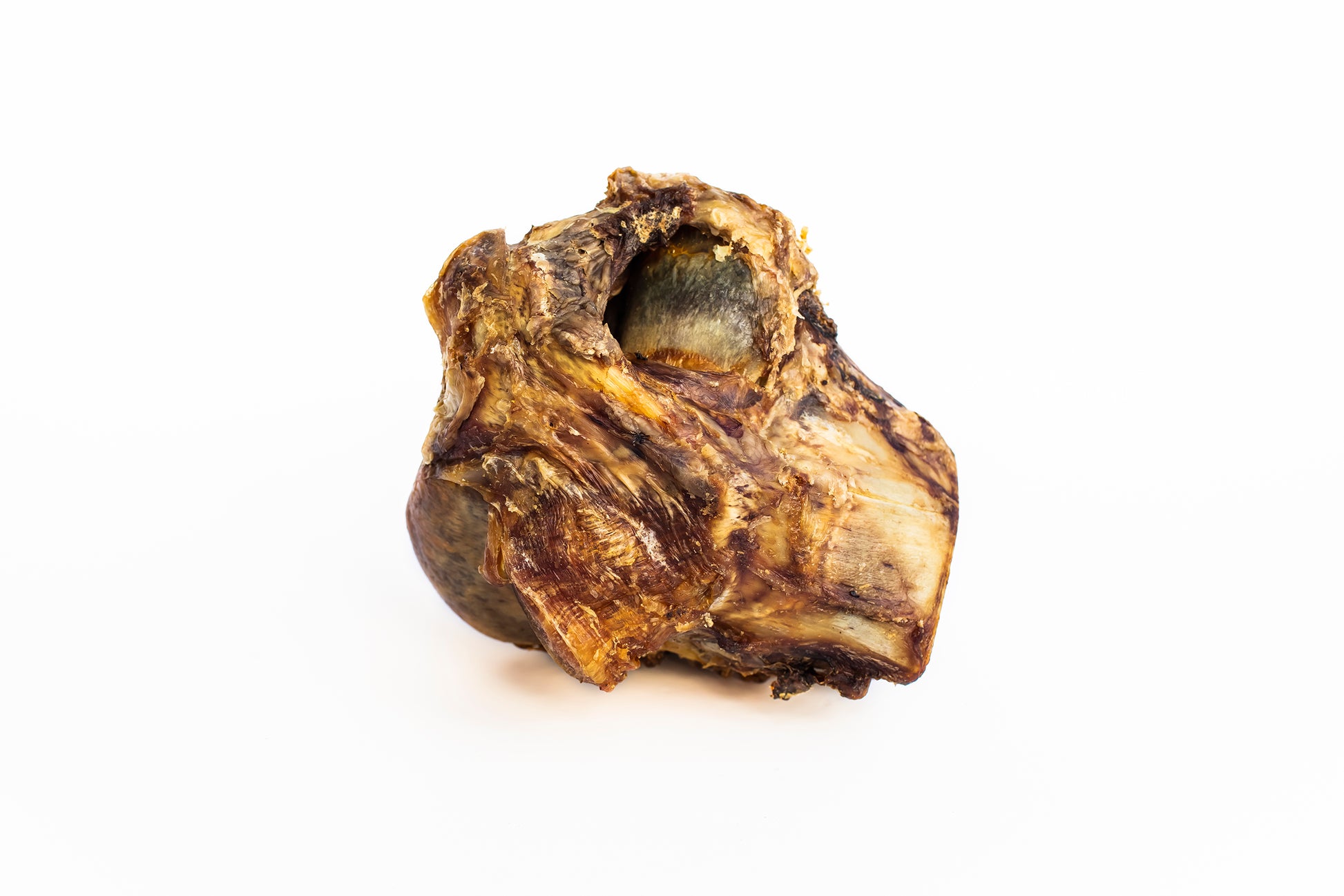 Beef knuckle bone for dogs showing a large, dense joint bone with attached cartilage and natural meat textures.